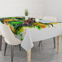 White printed tablecloth draped on dining table, green beer, coins, and clover pattern