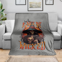Gray witch skull blanket with orange flame lettering and black hat graphic