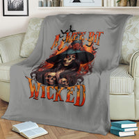 Gray witch skull blanket with portrait, black hat, and orange flame 'WICKED' text