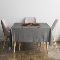 Gray tablecloth with Halloween witch skull graphic strip at center