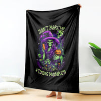 Black blanket hanging display with neon witch skull and 'GET THE FLYING MONKEY' text