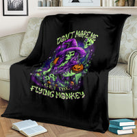 Black witch skull blanket draped on sofa with neon 'GET THE FLYING MONKEY' design