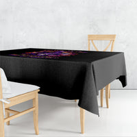 Black tablecloth with colorful witch skull graphic across the center