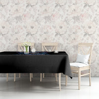 Black skull graphic tablecloth on a bench table with floral wall background