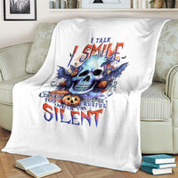 White throw blanket with blue skull graphic and “Silent” lettering, on couch