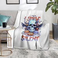 White throw blanket with blue bat skull and “Silent” typography, draped on couch