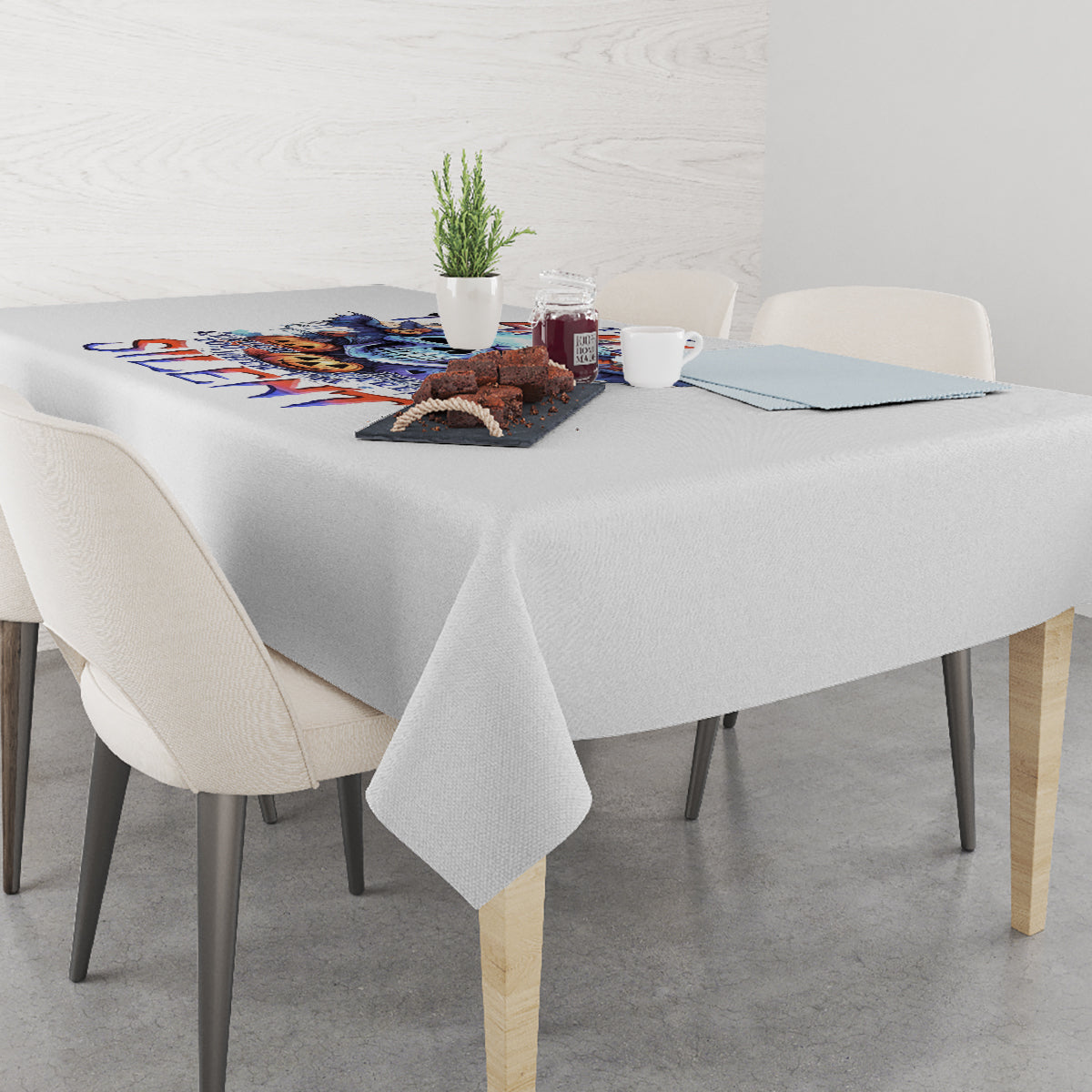 White tablecloth with colorful bat skull graphic center panel and draped edges