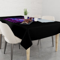 Black rectangular tablecloth with purple skull artwork on a dining table