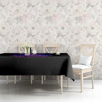 Black tablecloth with purple skull band design along the tabletop edge