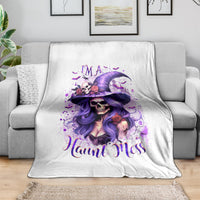 White Halloween skull witch hat blanket with purple graphic and flowers, draped on a sofa