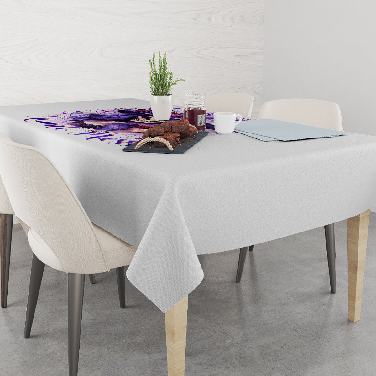 White tablecloth with purple witch skull graphic, center of table