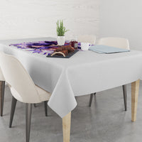 White tablecloth with purple witch skull graphic, center of table