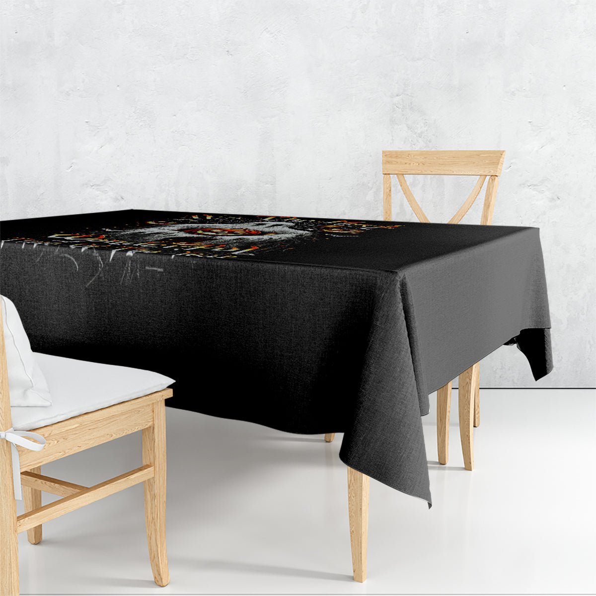 Black Halloween tablecloth with ghost-themed print, draped over square table