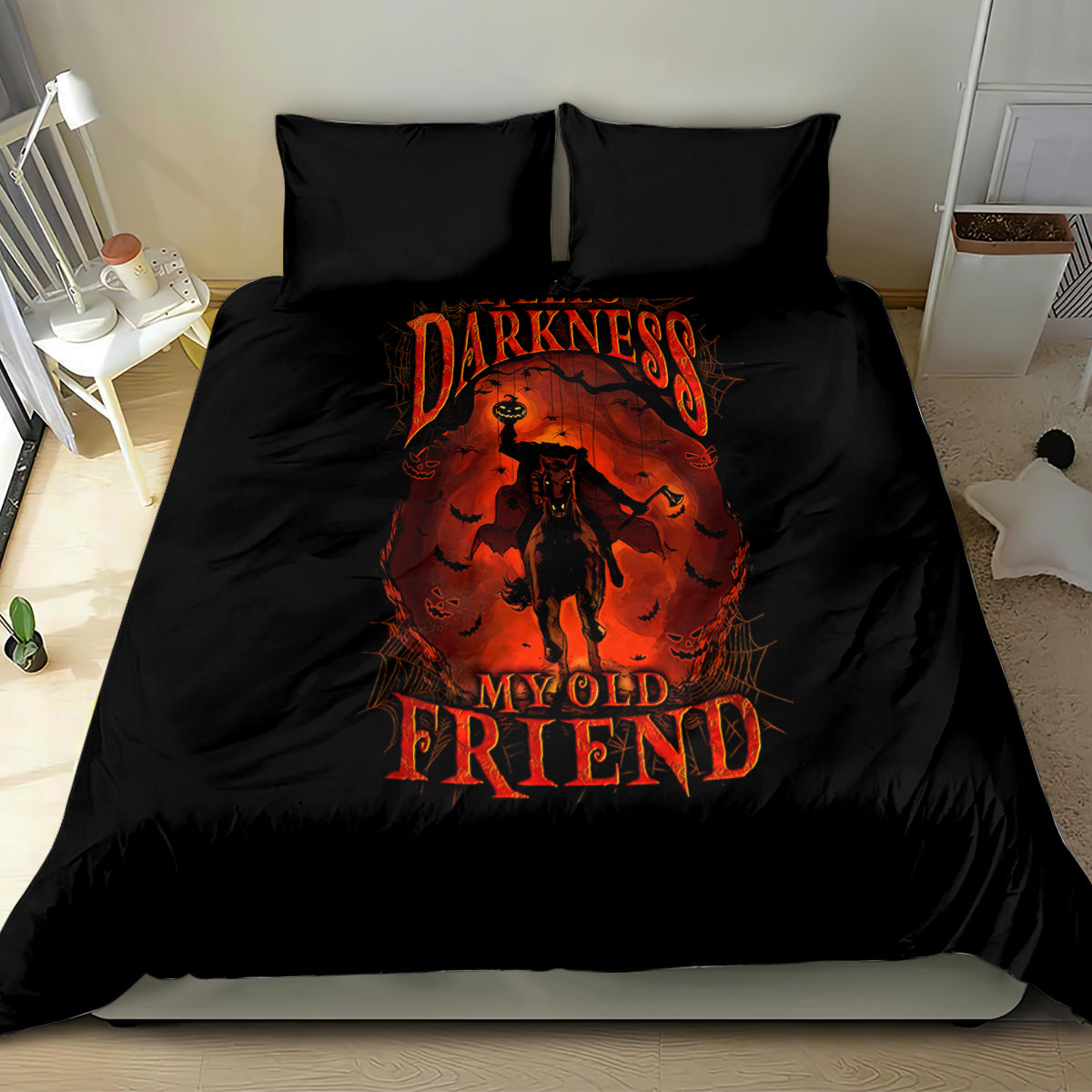 Black bedding set with orange skull-style figure graphic on duvet and two pillows