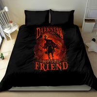 Black bedding set with orange skull-style figure graphic on duvet and two pillows