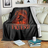 Black fleece blanket on couch with orange skull jack-o-lantern design and 'My Old Friend' text