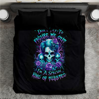Black bedding set shown from above with blue skull graphic and purple flower accents