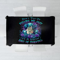 Black tablecloth with teal-blue skull and floral graphic and centered quote design