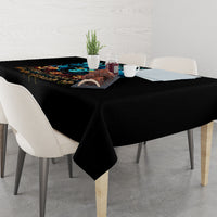 Black Halloween tablecloth with skull design, cloth corners hanging over dining table