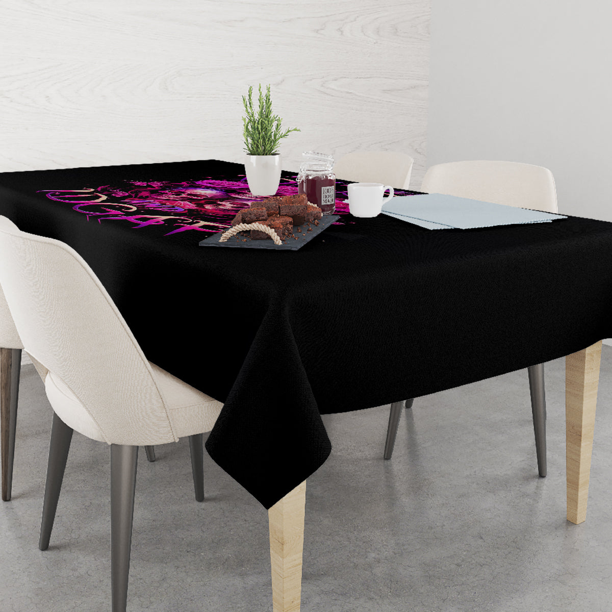 Black tablecloth on dining table with purple skull and roses design across top
