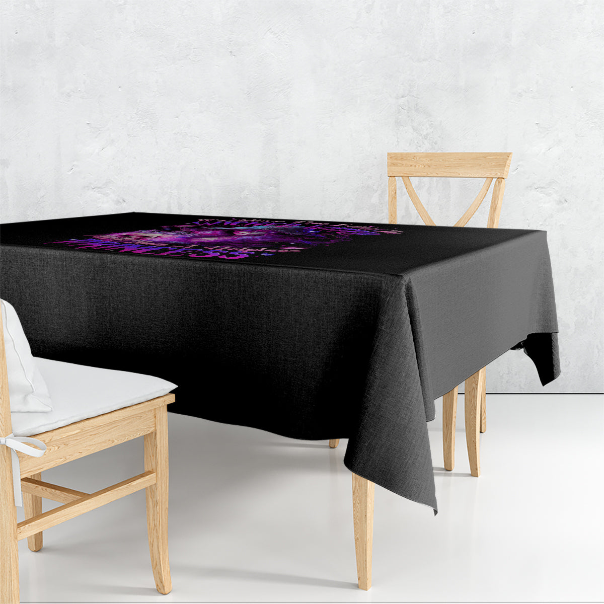 Black tablecloth with purple witch skull graphic, draped over table corners