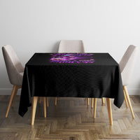 Black square tablecloth with small purple witch graphic centered on table
