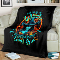 Black witch skull blanket on couch, featuring colorful witch hat skull graphic