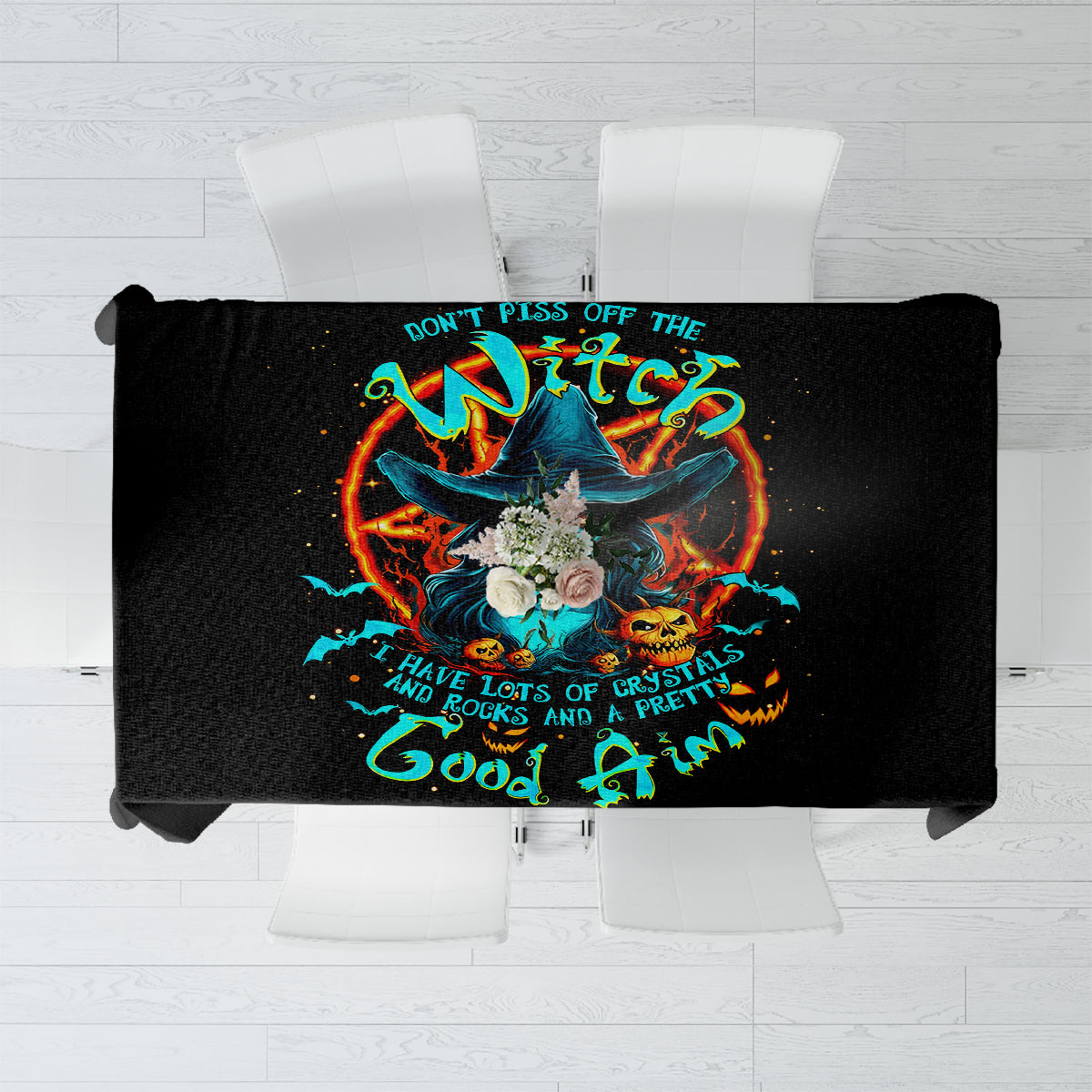 Black tablecloth featuring a colorful witch skull graphic with text in the center