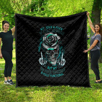 Black quilted blanket with teal skull-and-rose design, displayed outdoors