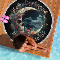 Black moon-and-skull beach blanket with floral accents and fringe edging