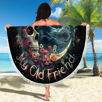 Round moon skull beach blanket with floral artwork and white fringe, held up outdoors