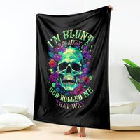 Black skull and flower print blanket hanging, bright multicolor graphic text.