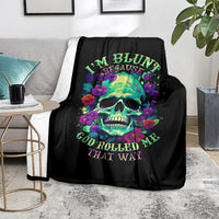 Black skull and flower graphic blanket on a sofa, vibrant multicolor lettering.