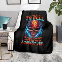 Black skull devil graphic blanket with bright flame skull and bold text, on sofa