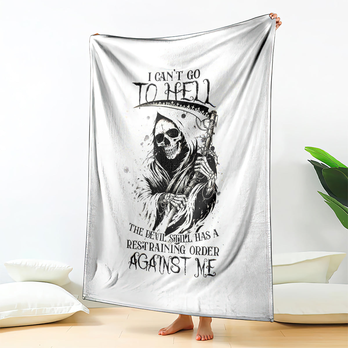 White skull reaper graphic blanket draped with black skull and lettering print