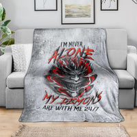 Grey blanket with devil skull graphic and red lettering, draped over sofa
