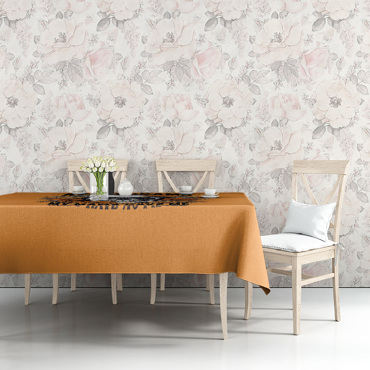 Orange tablecloth with floral skull print on table front
