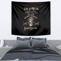 Black skull graphic tapestry with bold text and banner-style layout, hanging on a wall