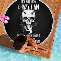 Black round beach blanket with skull graphic and fringed edge