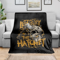Black skull and axe graphic blanket with gold text, draped over sofa