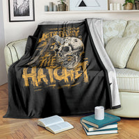 Black skull and axe graphic blanket with gold text, folded over armrest