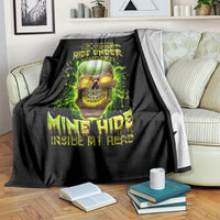 Black throw blanket with green skull graphic, “Hide Under Your Bed” lettering