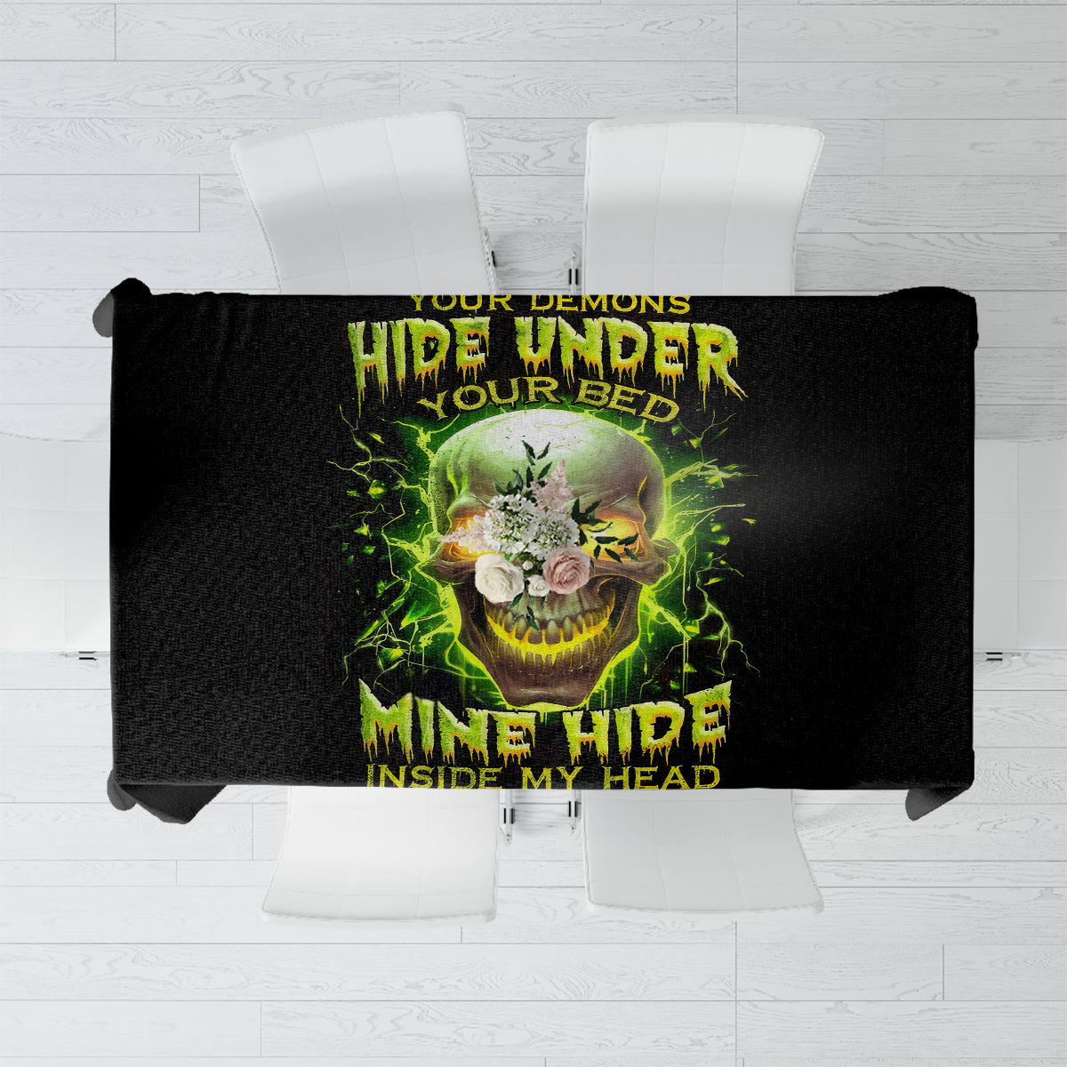 Black tablecloth laid flat featuring a large neon skull design