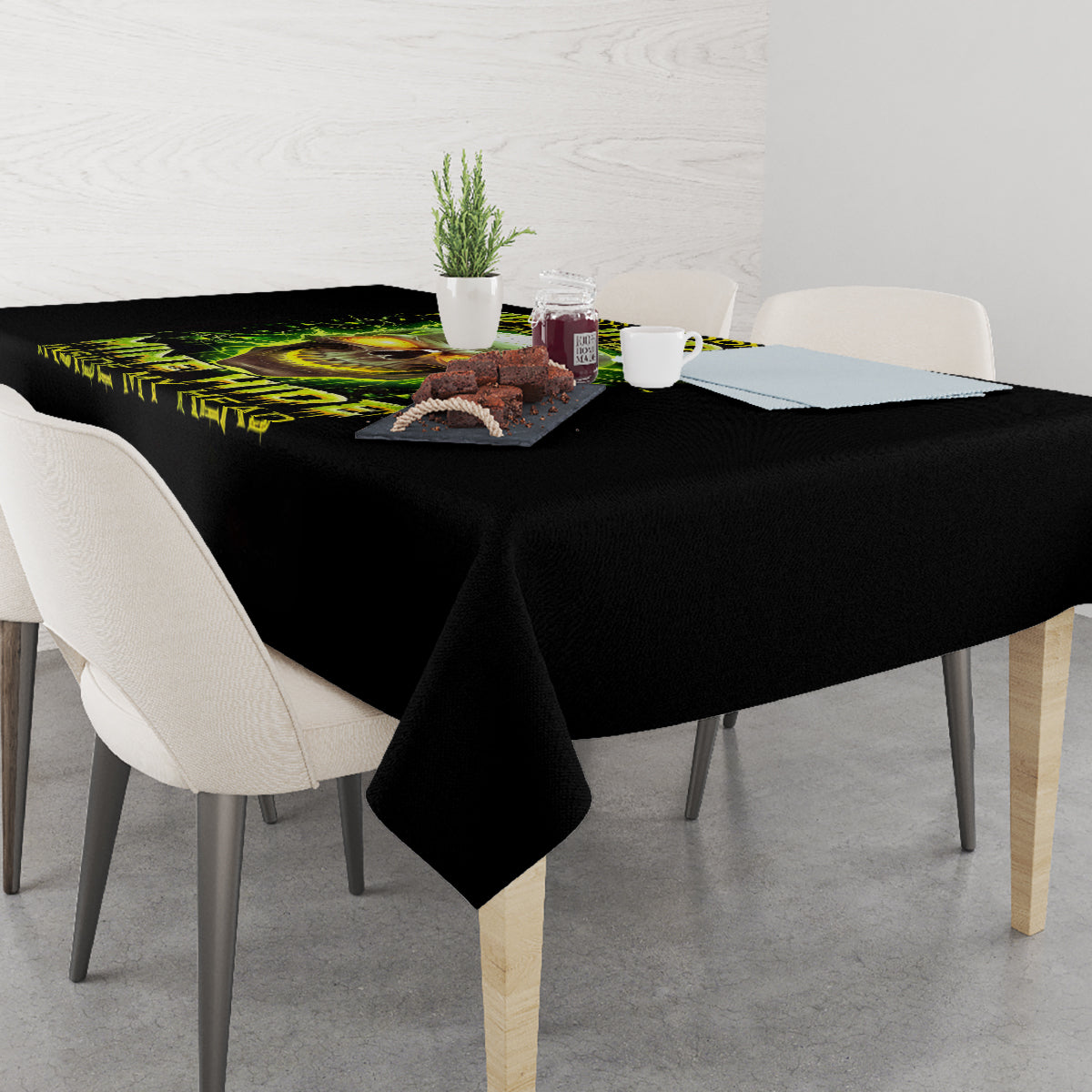 Black tablecloth with neon skull print on a dining table, overhanging edge