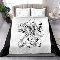 White bedding set with two pillows and black skeleton rock-paper-scissors graphic on duvet