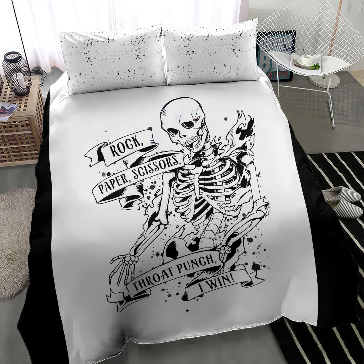 White duvet and two pillows featuring black skeleton flames and rock-paper-scissors design