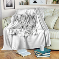 White skull graphic blanket draped on sofa, Rock Paper Scissors and 'Throat Punch' art