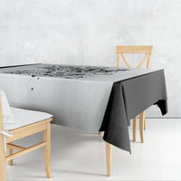 White tablecloth with black skull game graphic, folded corner drape