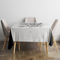 White tablecloth with black skull game center print on square dining table