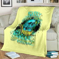 Lime yellow blanket on couch with teal skull graphic and 'Salty Choice' print